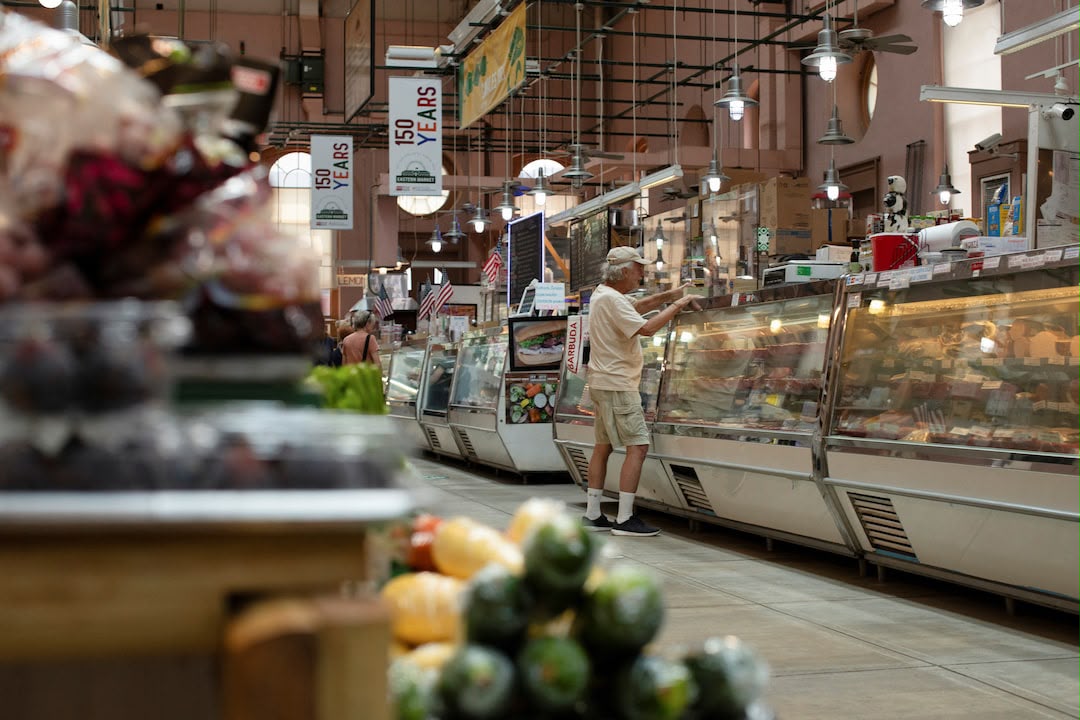 A man shops for meat at Eastern Market